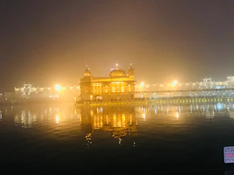 A peaceful evening scene with the temple illuminated by soft lantern light.