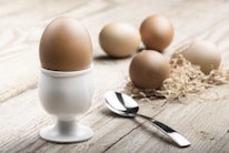 white ceramic egg holding near spoon