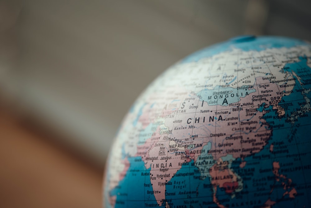 close up photo of blue desk globe