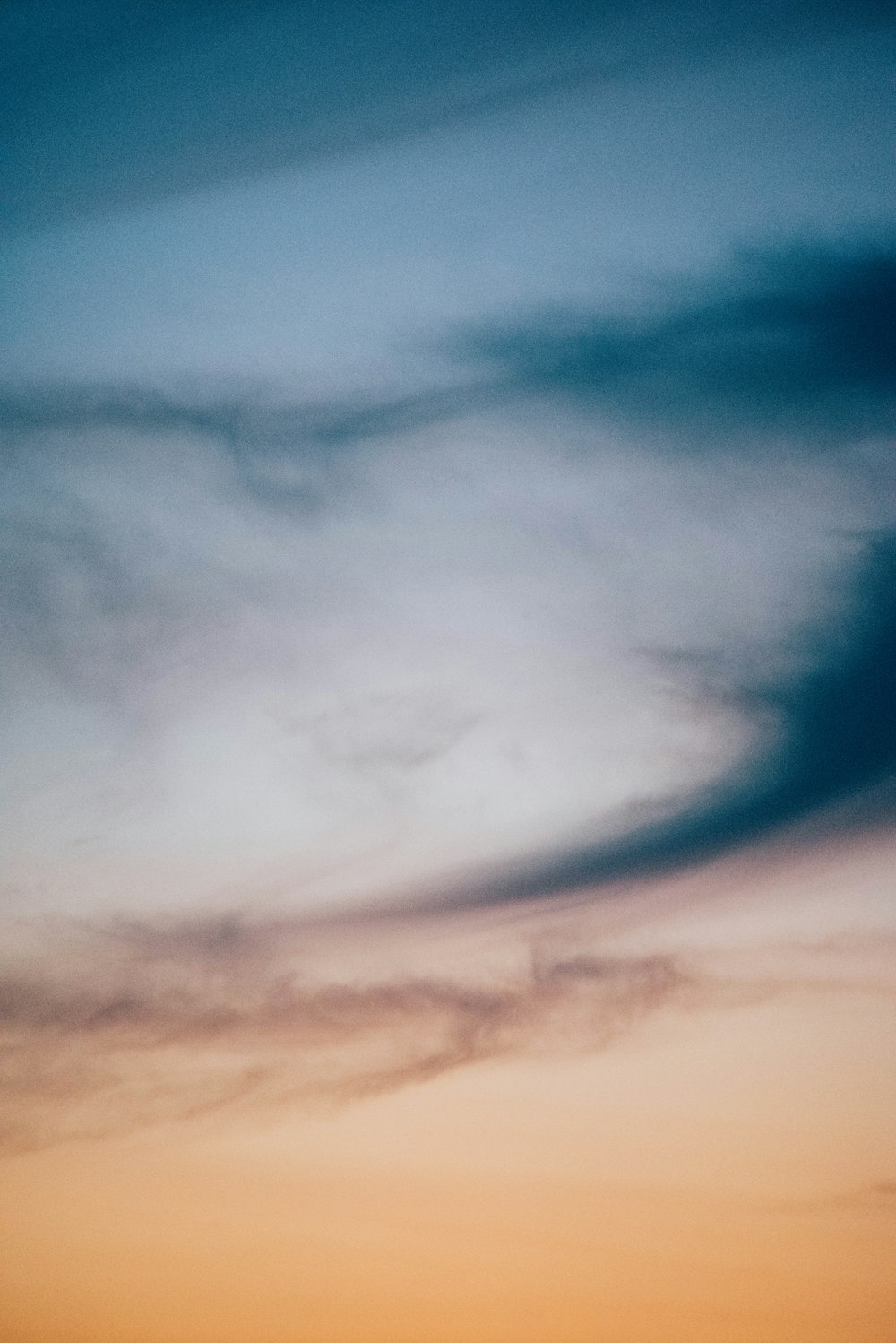 a plane flying in the sky at sunset