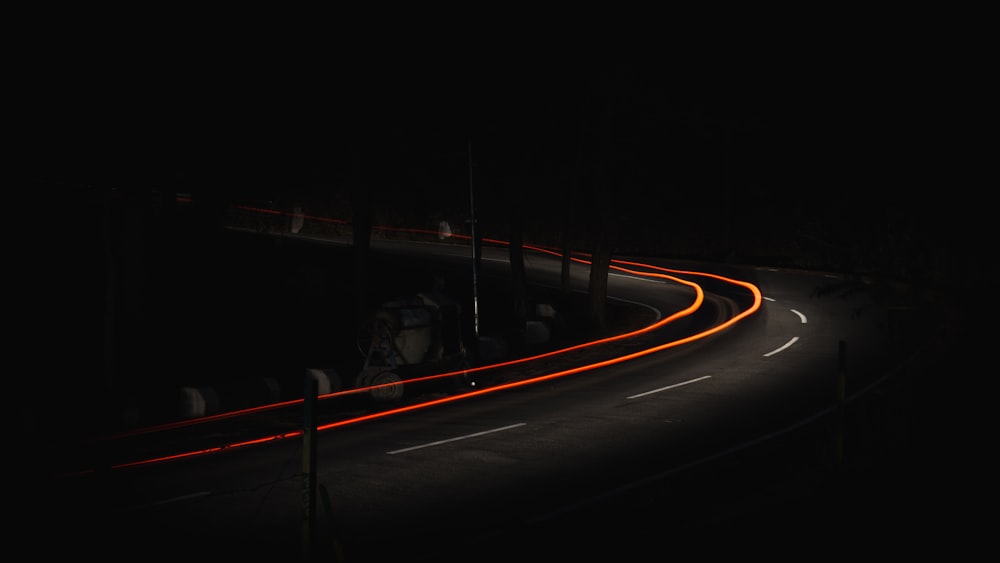 time lapse photo of car on road