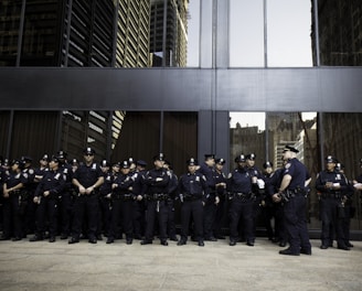 group of police standing near grey building