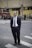man standing near road next to people during daytime