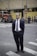 man standing near road next to people during daytime