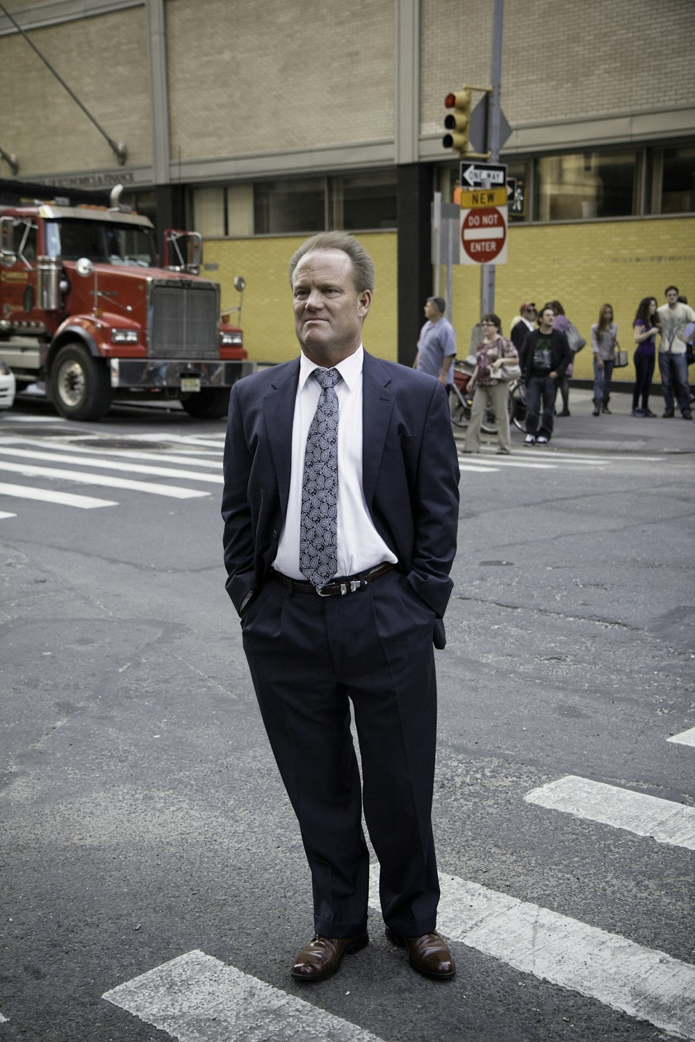 man standing near road next to people during daytime