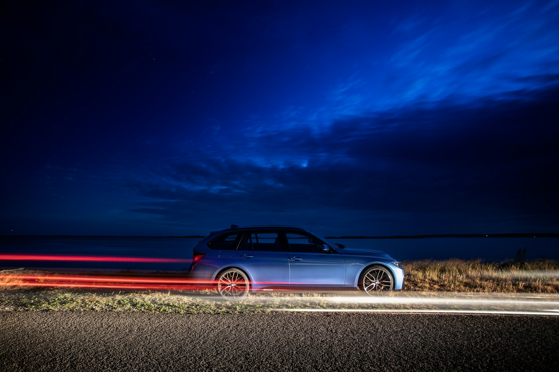 blue SUV running on the road during nighttime