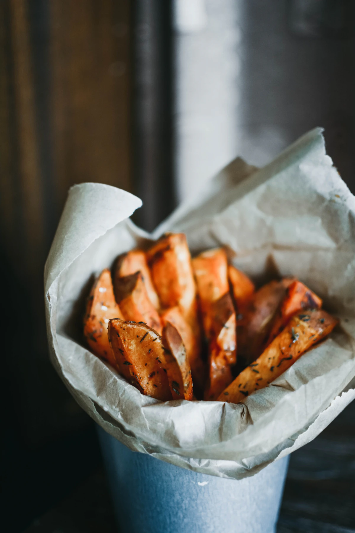 Golden crispy french fries served in a tray at a restaurant
