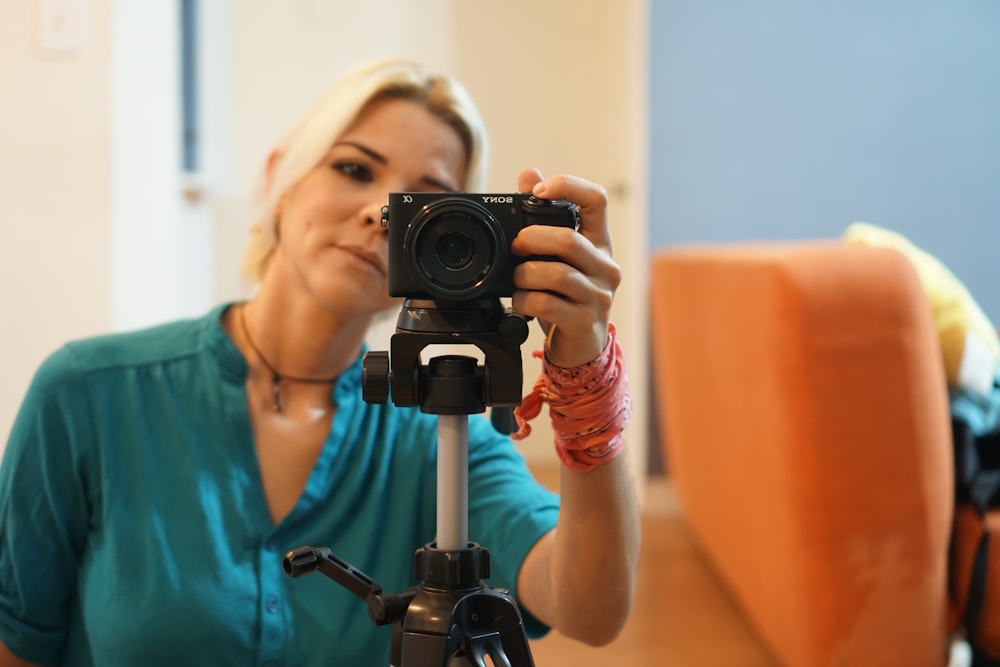 woman in blue dress holding the camera