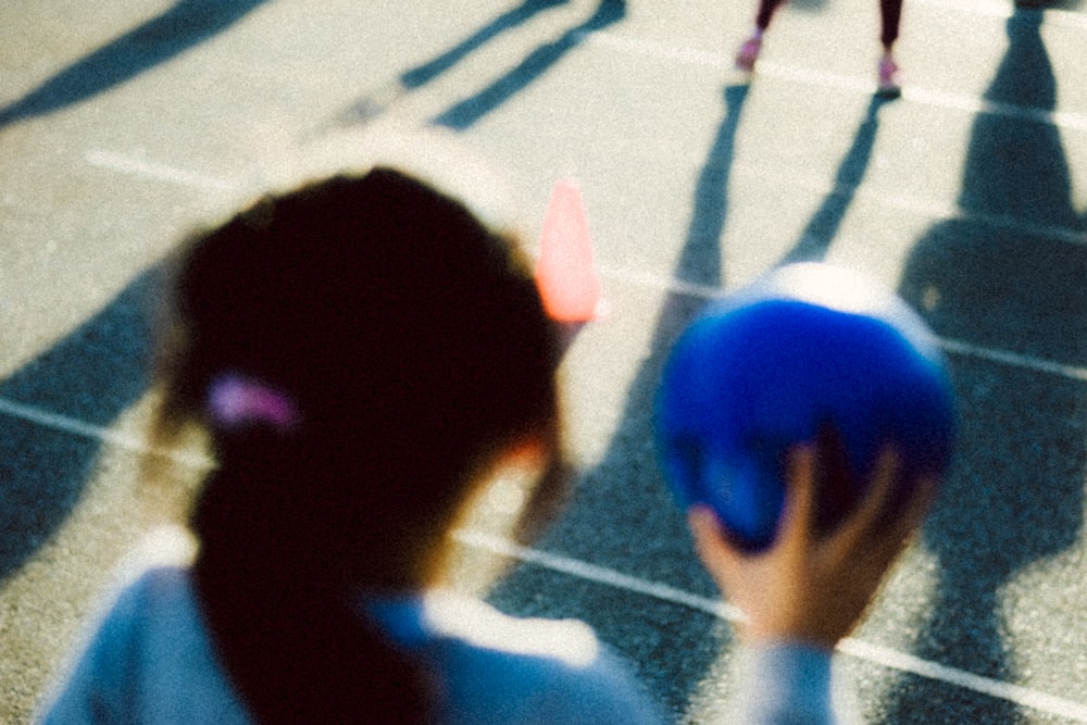 girl holding blue ball