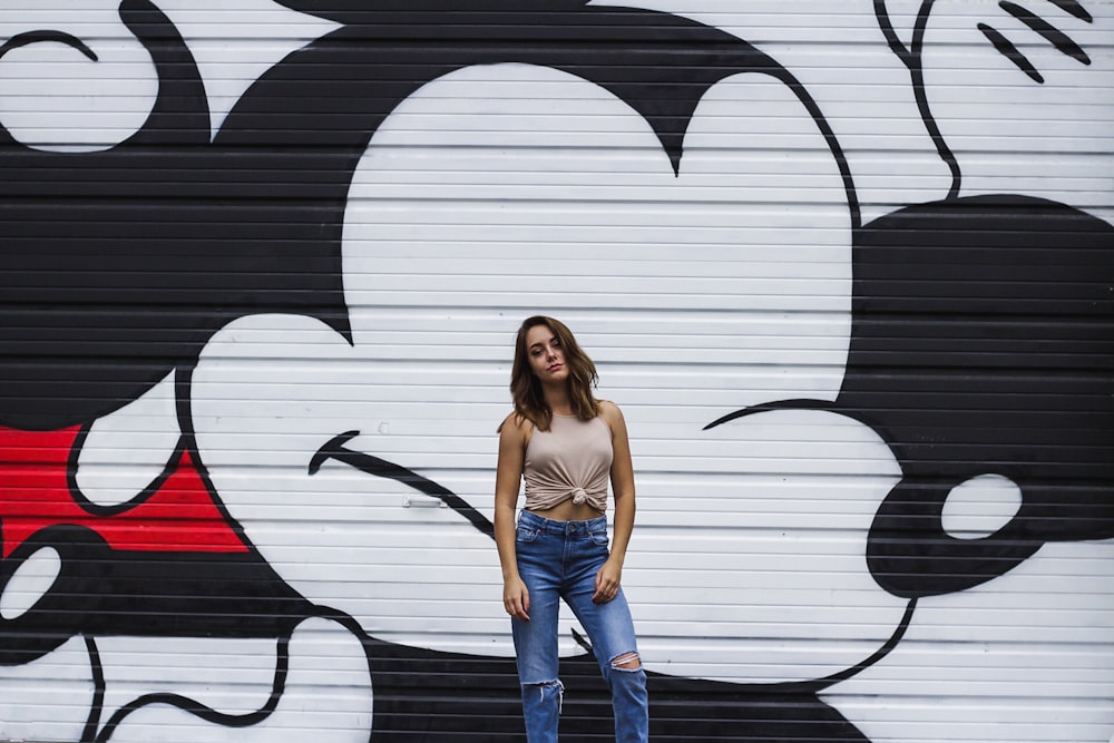 woman wearing brown blouse with black and white Mickey Mouse graffiti at daytime