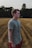 man in gray crew-neck shirt and red bottoms standing near wheat field