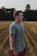 man in gray crew-neck shirt and red bottoms standing near wheat field