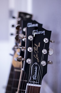 Close-up of a vintage Les Paul guitar displayed at an interactive exhibit, with visitors admiring it.