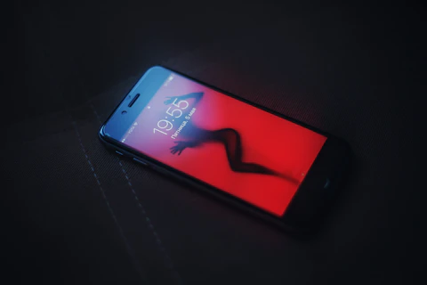 A phone that experienced connection issues. with a sexy woman as the screensaver.