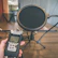 A podcast or recording setup on a wooden desk, featuring a pop filter mounted on a microphone stand and a hand-held recording device labeled H4n Pro. The workspace appears organized, with additional microphones visible in the background. The overall setting suggests an environment prepared for audio recording or broadcasting.