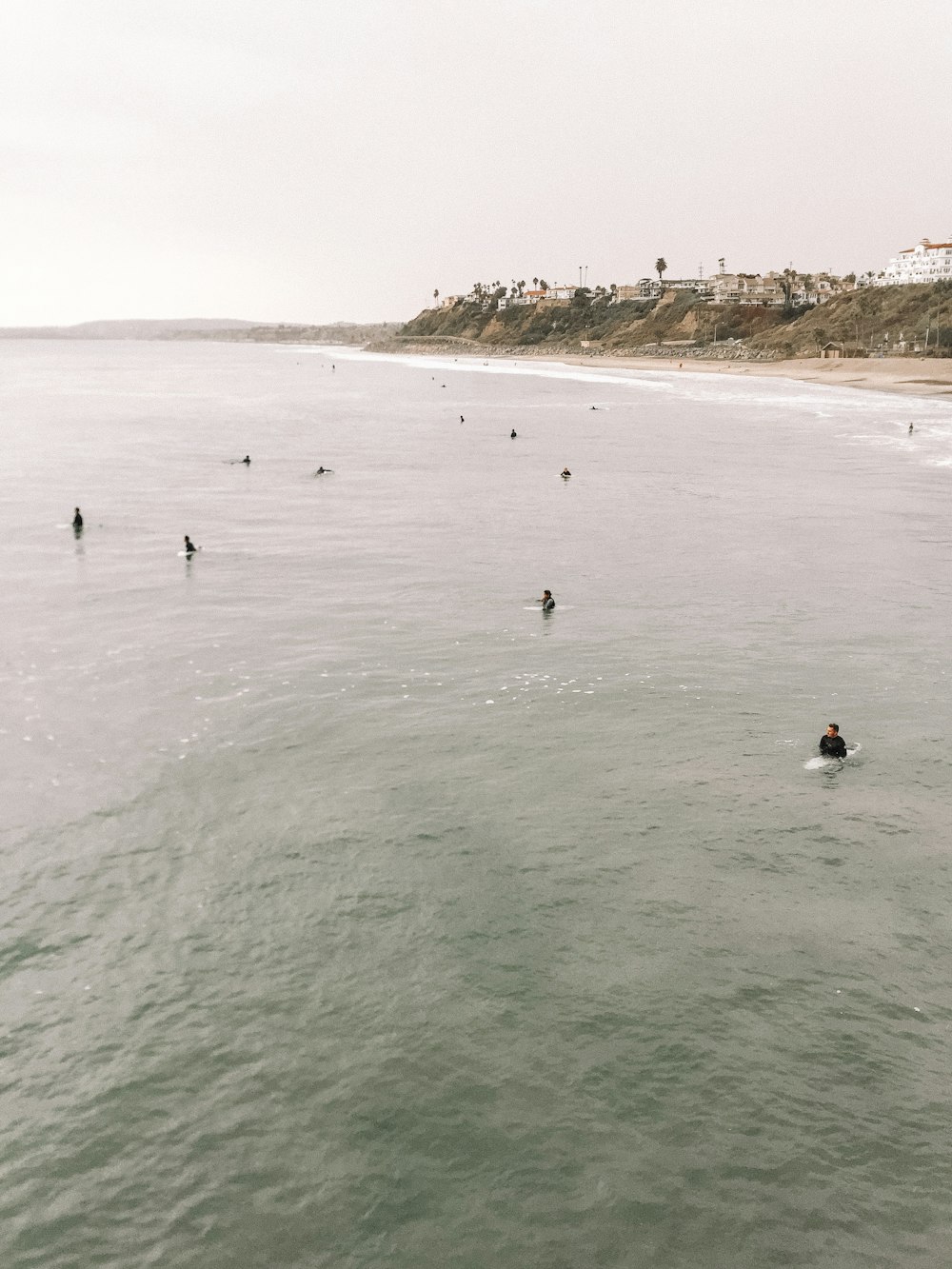 a group of people swimming in the ocean