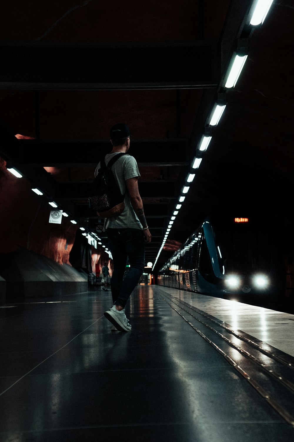 man standing at train station