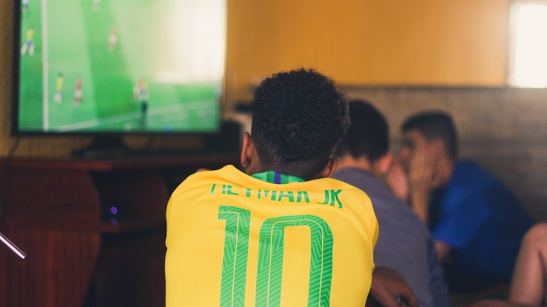 man wears yellow and green jersey shirt