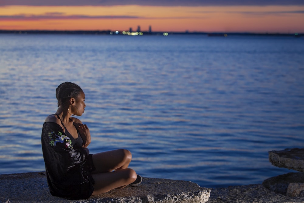 woman sitting near sea