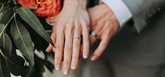 couple wearing silver-colored rings