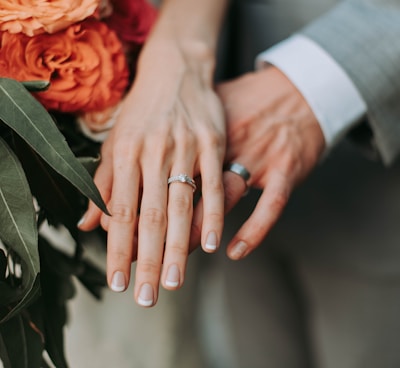 couple wearing silver-colored rings