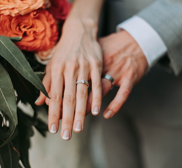 couple wearing silver-colored rings