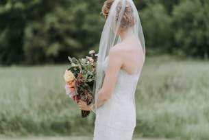 woman holding bouquet of flower