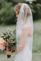 woman wearing white wedding dress with veil