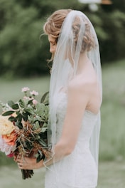 woman wearing white wedding dress with veil