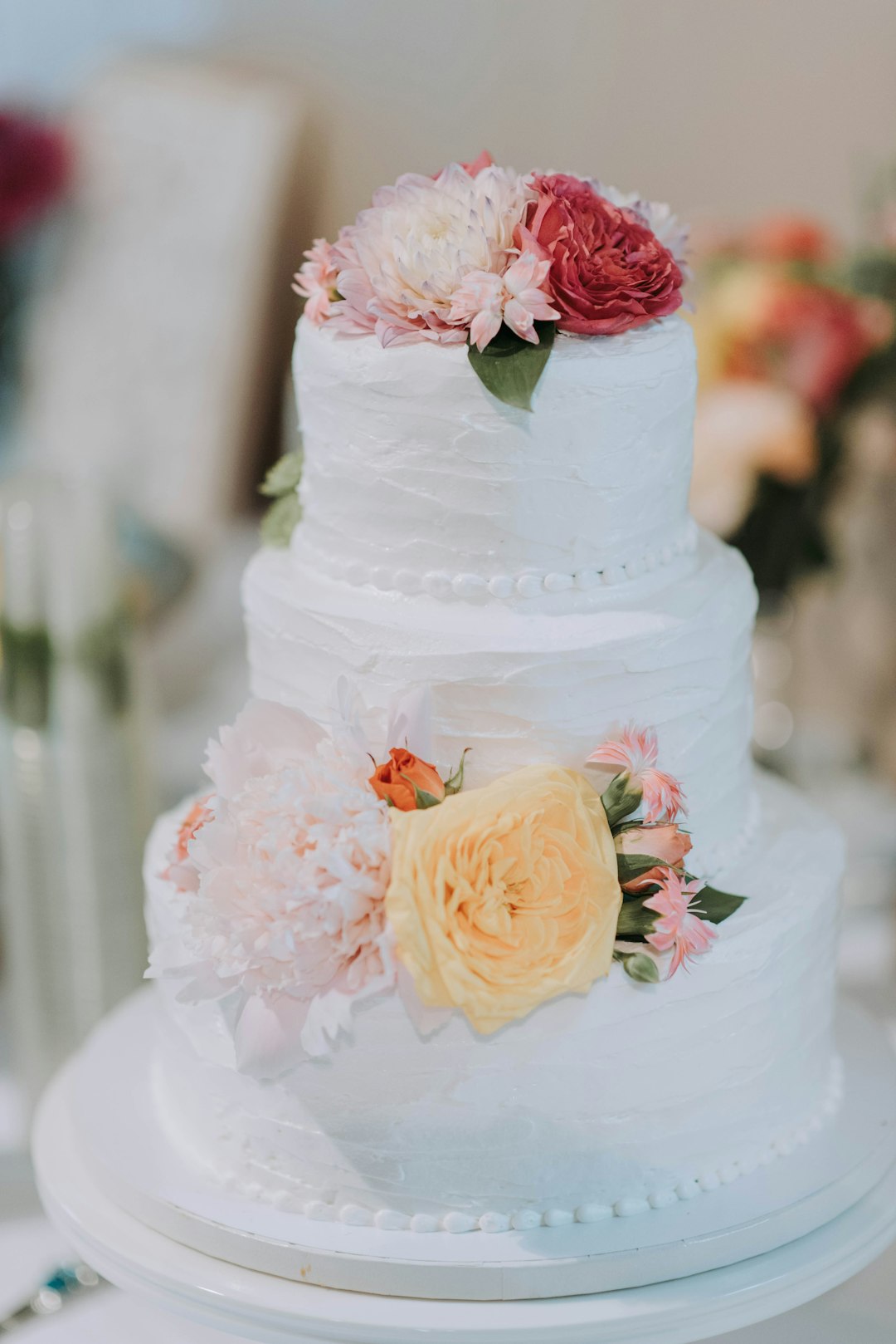 round white icing-covered 3-layer cake