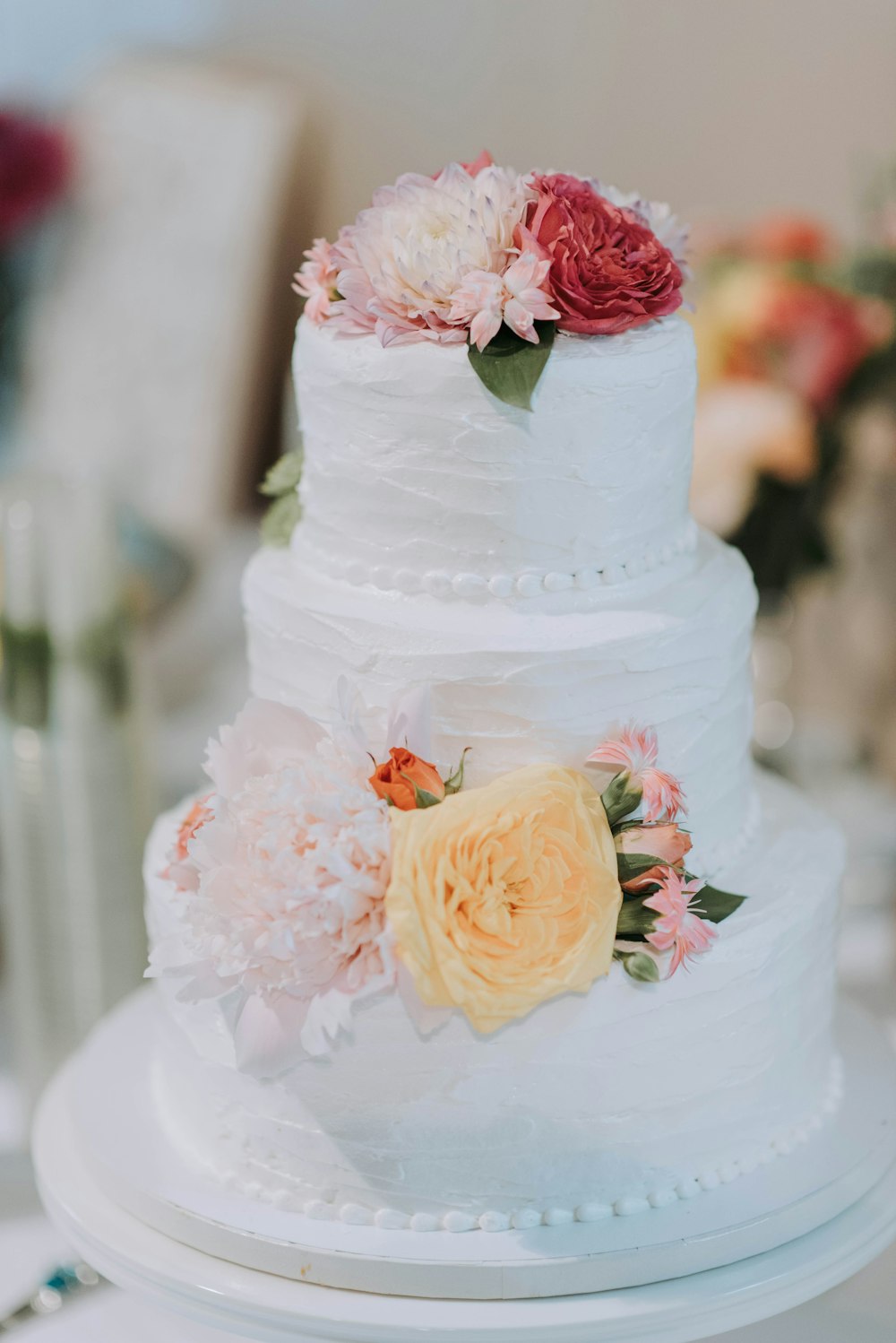 round white icing-covered 3-layer cake