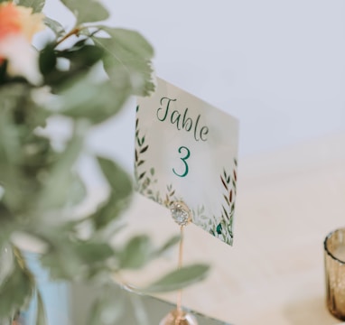 a table number on a table with a vase of flowers