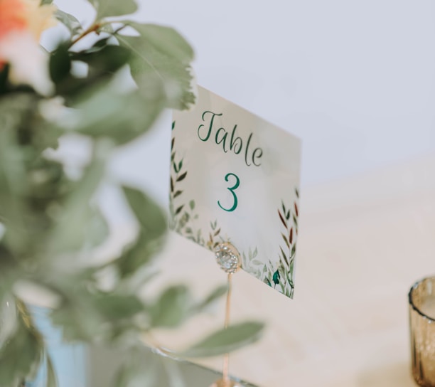 a table number on a table with a vase of flowers