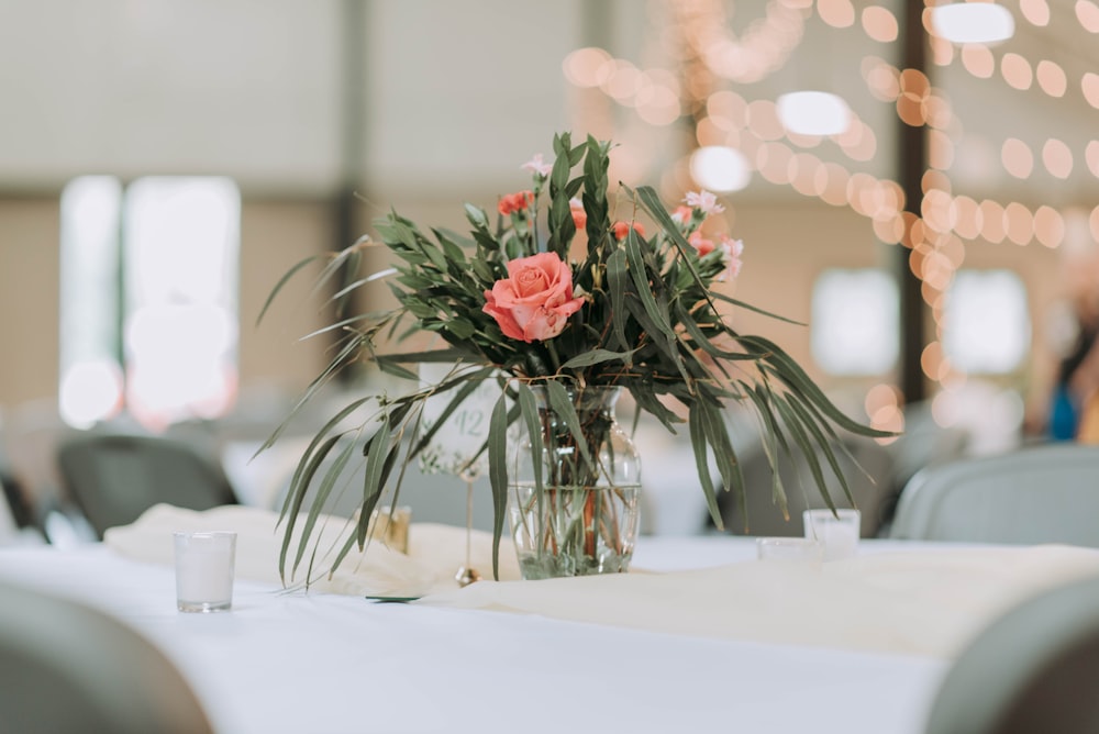 pink flowers in clear glass vase