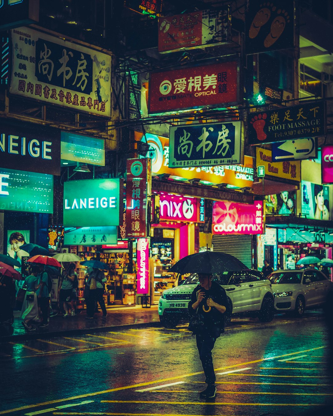 person walking on grey and black road at nighttime