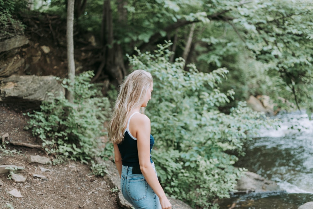 woman standing in front of river