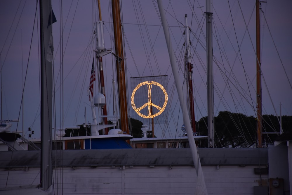 Peace logo on white sail mast