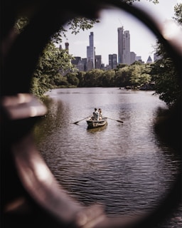 man and woman riding on gray wooden boat