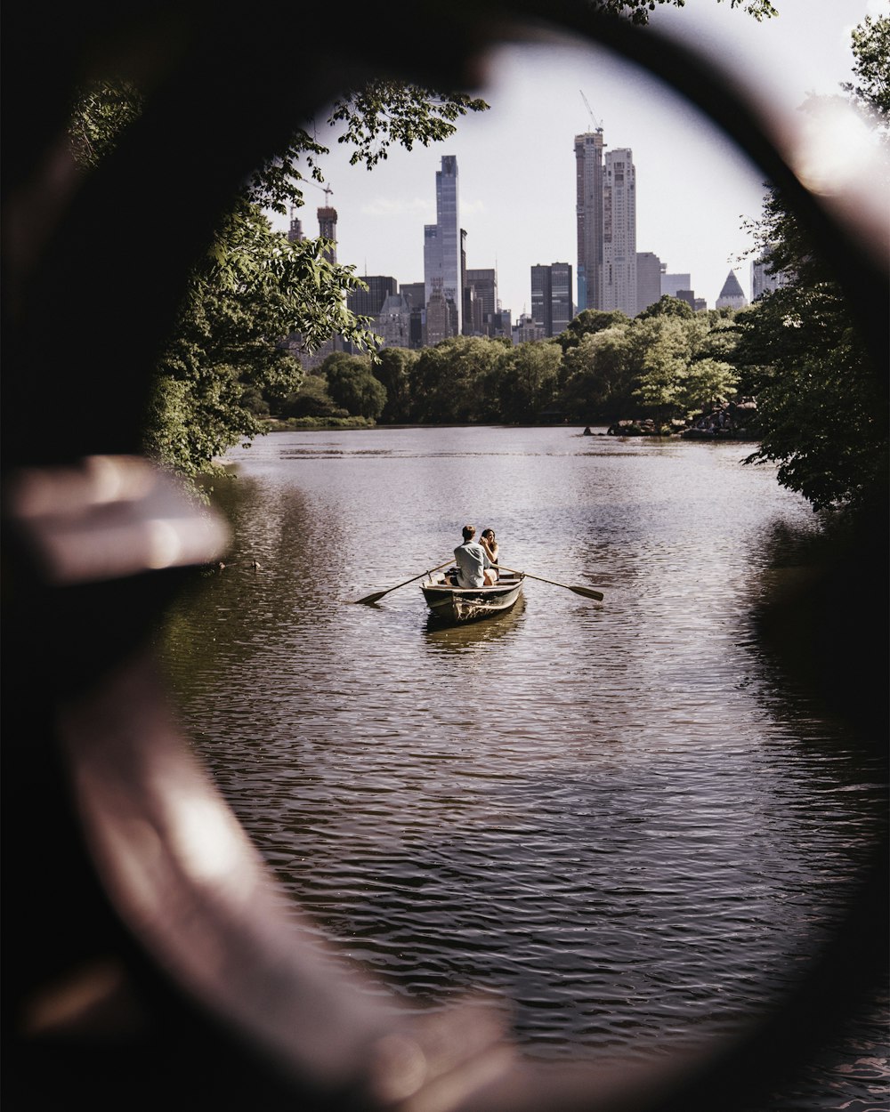 man and woman riding on gray wooden boat