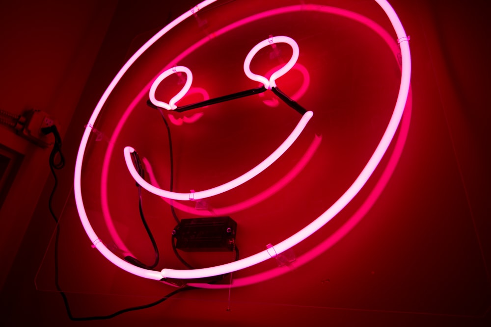 pink emoji neon signage