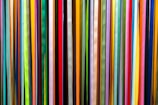 a large group of multicolored sticks in a room