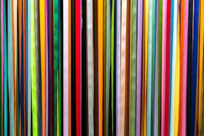 a large group of multicolored sticks in a room