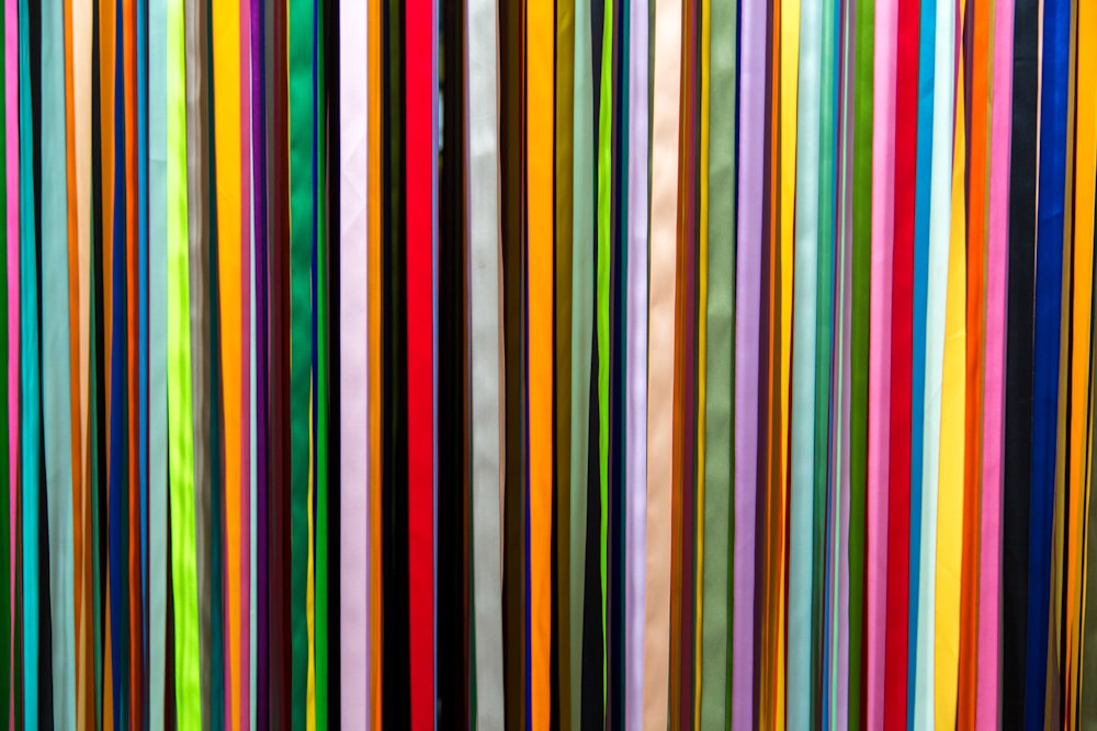 a large group of multicolored sticks in a room