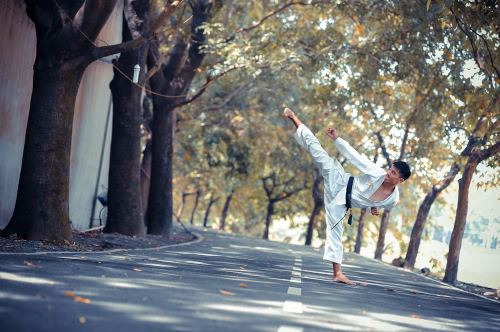 man wearing karate gi standing on road