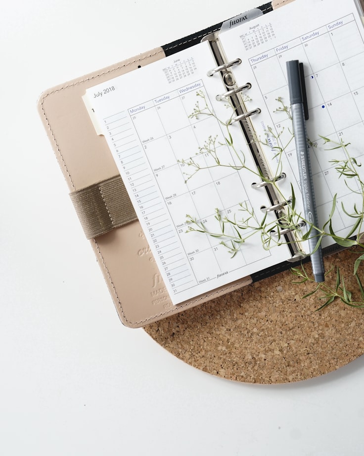 A calendar book with a pen on it, the sort of working document a good wedding brief turns into