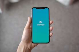 person holding space gray iPhone X