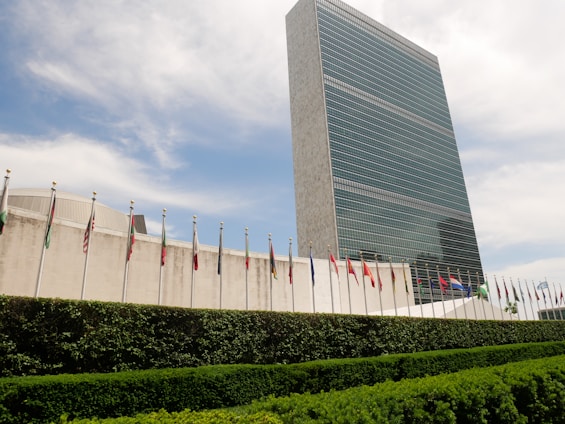 Modern corporate office building with international flags representing global partnerships.