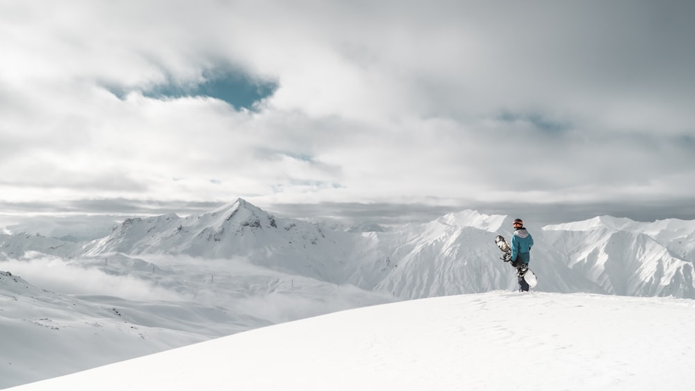 person standing on white snow cliff