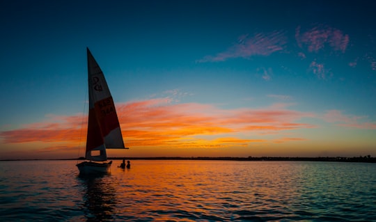 silhouette photo of white sail boat in Bacalar Mexico