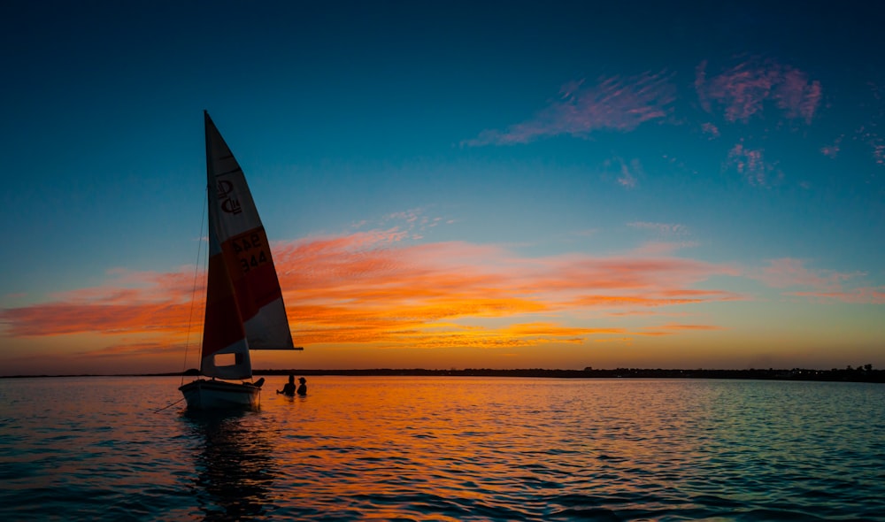 silhouette photo of white sail boat